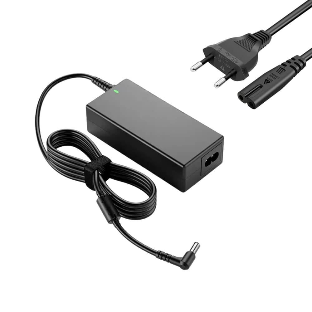 Black laptop power adapter kit on a white background featuring a rectangular power brick with a glowing green LED, a coiled DC cable with a right-angle tip and velcro strap, and a separate AC power cord with a European Type F plug and C7 connector
