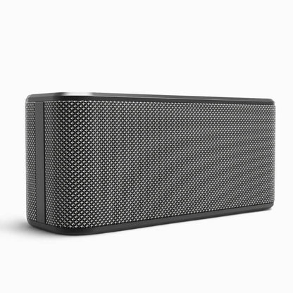 A dark gray rectangular portable speaker with rounded corners and a textured silver mesh grille on a white background